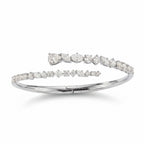 My Store 4 contemporary white gold bypass bangle featuring mixed round, marquise, and pear-cut diamonds.