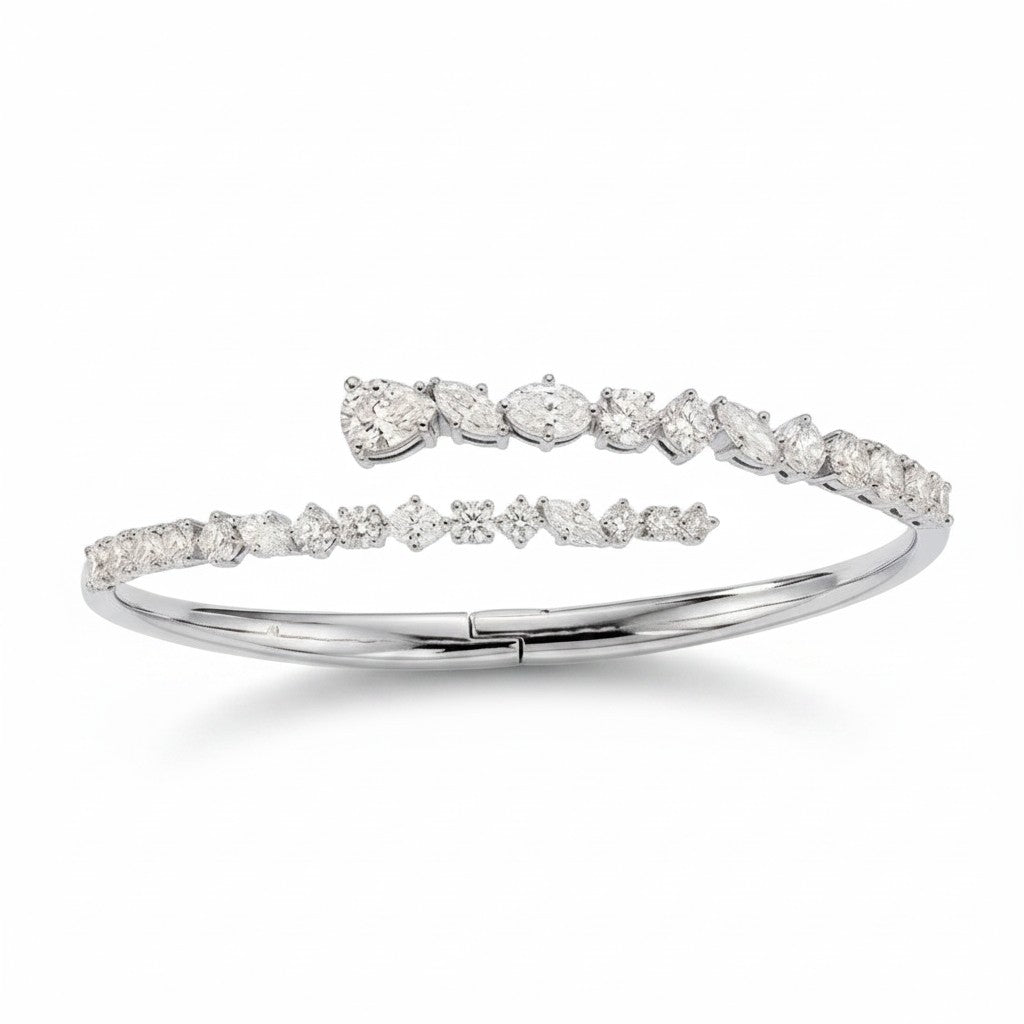 My Store 4 contemporary white gold bypass bangle featuring mixed round, marquise, and pear-cut diamonds.