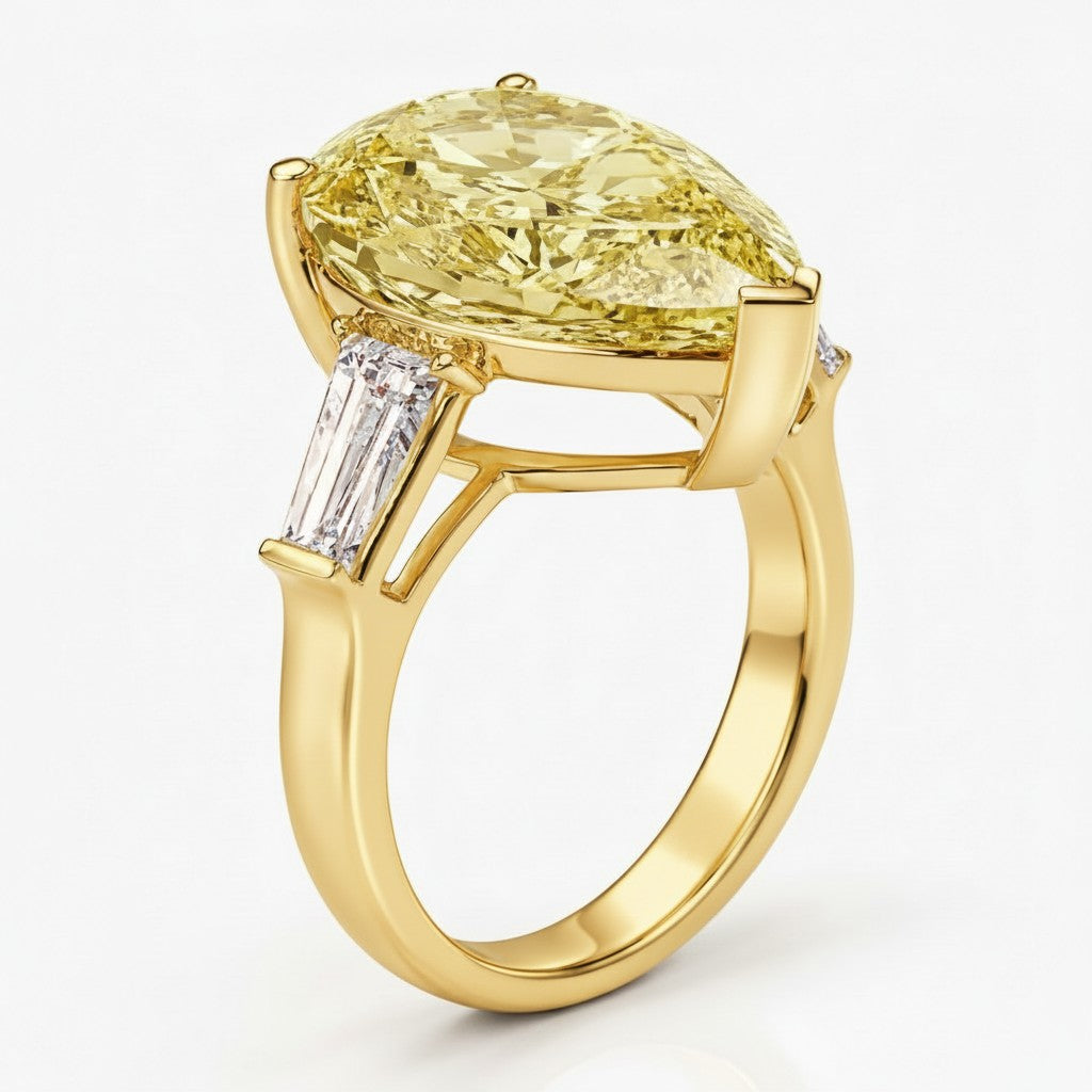 My Store 4 18K yellow gold trilogy ring featuring a pear-cut yellow diamond centerpiece and baguette side diamonds.