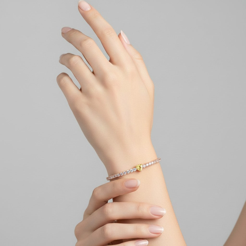 My Store 4 tennis bracelet featuring a central fancy yellow heart-cut diamond surrounded by round white diamonds.