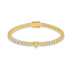 My Store 4 yellow gold tennis bracelet featuring a central heart-cut yellow diamond and round white diamond links.