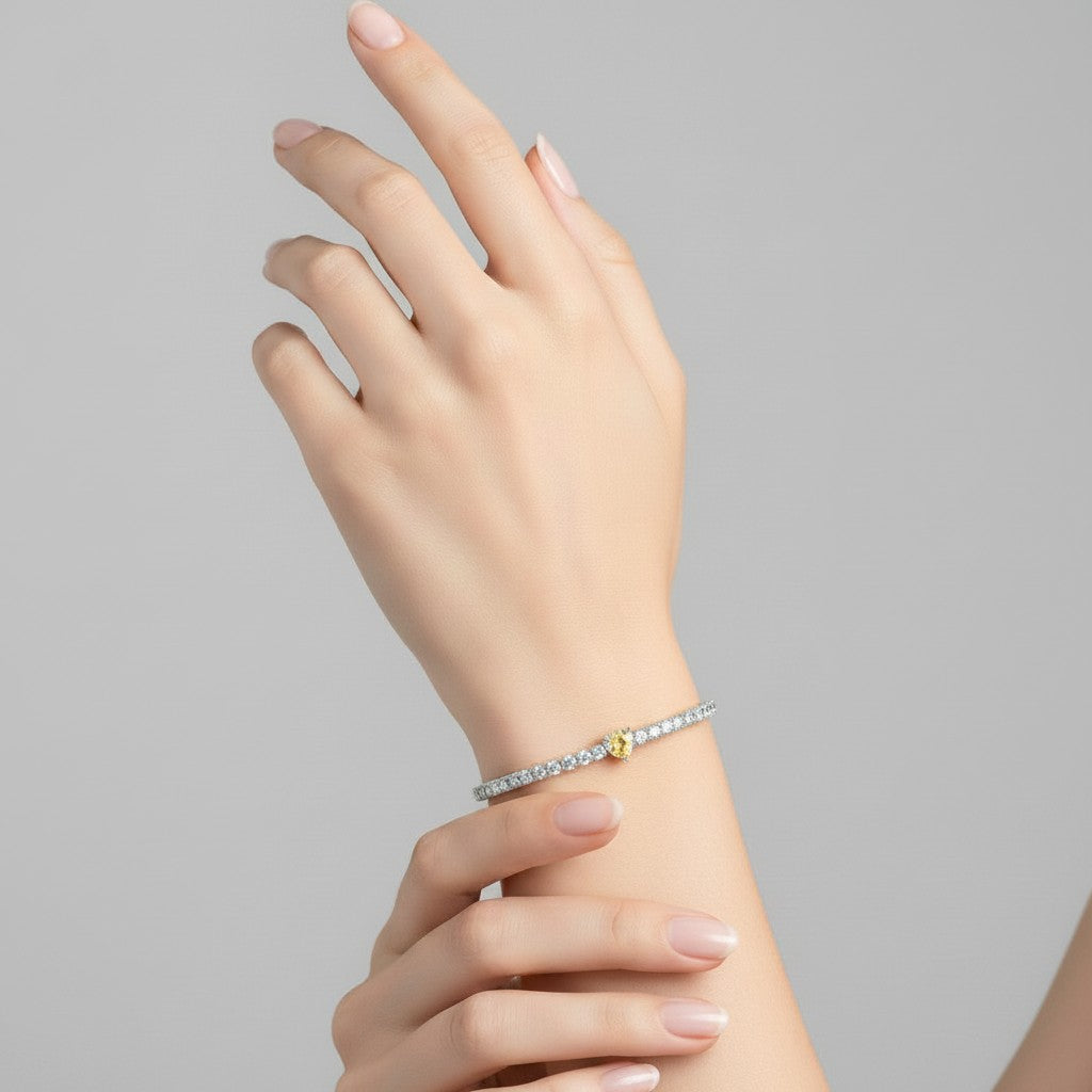 My Store 4 tennis bracelet featuring a central fancy yellow heart-cut diamond surrounded by round white diamonds.