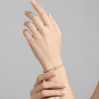 My Store 4 tennis bracelet with a central yellow heart-cut diamond and round white diamonds on a woman's wrist