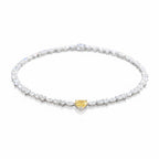 My Store 4 tennis necklace featuring a central yellow heart-cut diamond surrounded by mixed-cut white diamonds