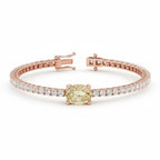 My Store 4 tennis bracelet featuring a central oval-cut fancy yellow diamond flanked by round white diamonds in gold.