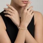 My Store 4 tennis bracelet featuring a central fancy yellow oval-cut diamond and round white diamonds in gold