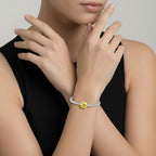 My Store 4 tennis bracelet featuring a central oval-cut fancy yellow diamond and white diamond line on a model