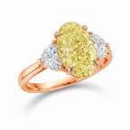 My Store 4 18K solid gold trilogy ring featuring a fancy yellow oval lab-grown diamond flanked by two side diamonds.