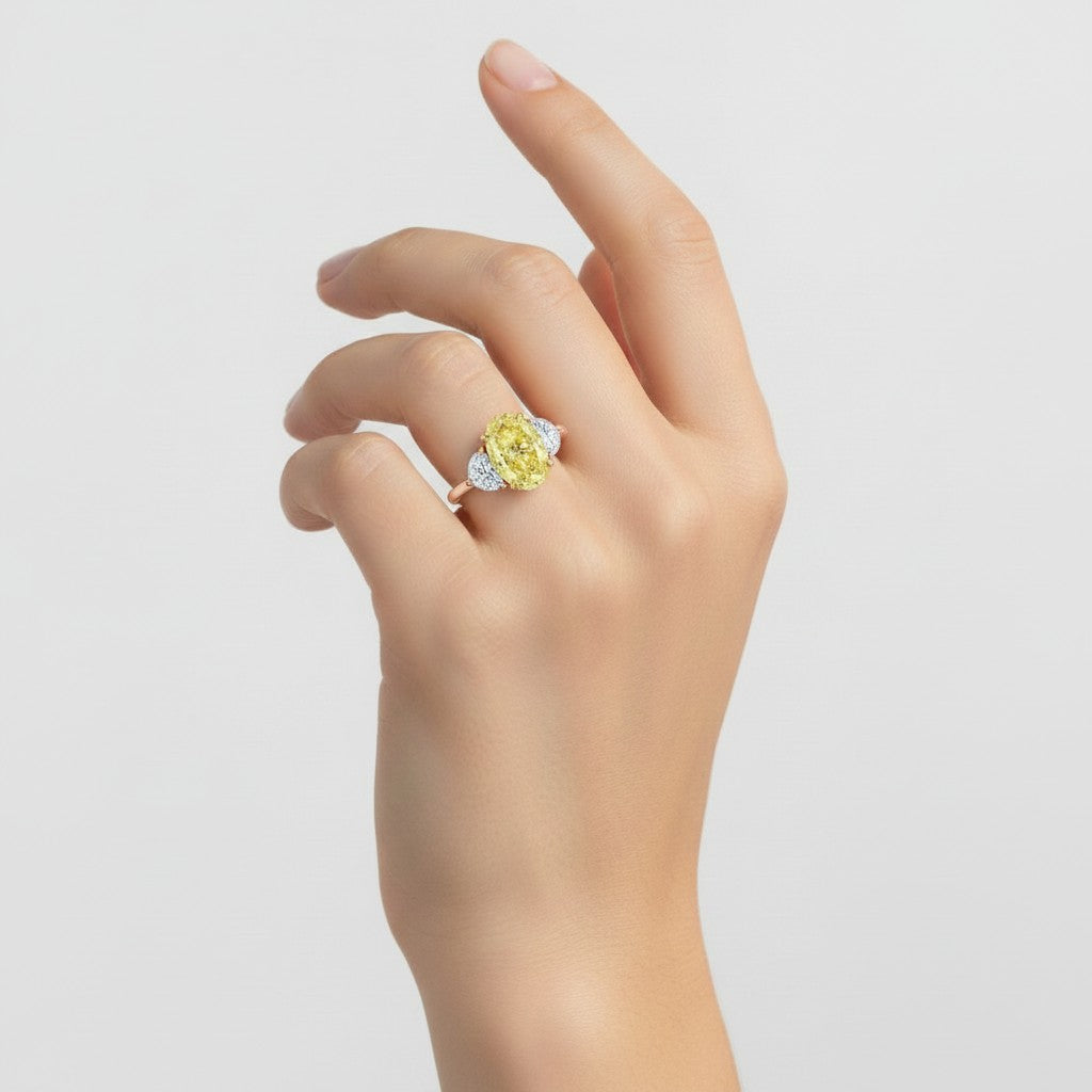 My Store 4 18K solid gold trilogy ring featuring a fancy yellow oval lab-grown diamond on a woman's hand
