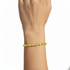 My Store 4 fancy yellow pear-cut diamond tennis bracelet worn on a wrist, featuring 3-prong gold settings.