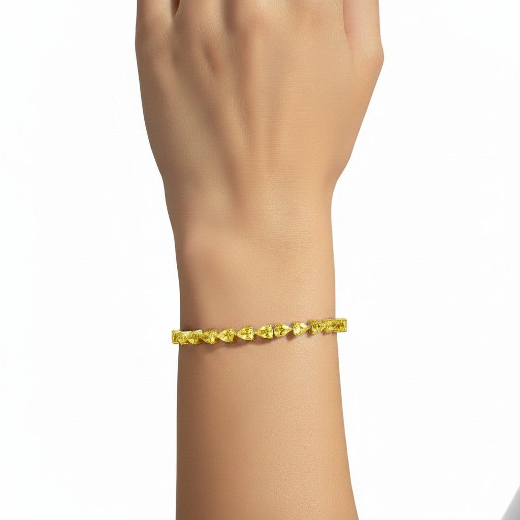 My Store 4 fancy yellow pear-cut diamond tennis bracelet worn on a wrist, featuring 3-prong gold settings.