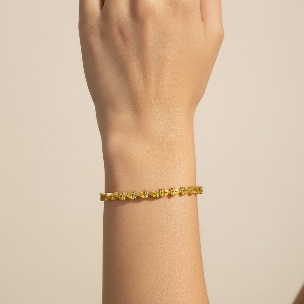 My Store 4 yellow gold tennis bracelet featuring a continuous row of fancy yellow pear-cut diamonds on a wrist.