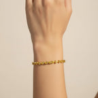 My Store 4 yellow gold tennis bracelet featuring a continuous row of fancy yellow pear-cut diamonds on a wrist.