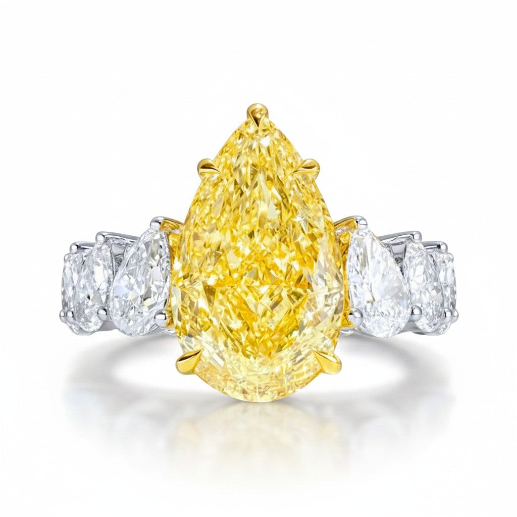 My Store 4 18K gold ring featuring a large pear-cut fancy yellow lab diamond flanked by smaller white pear diamonds.