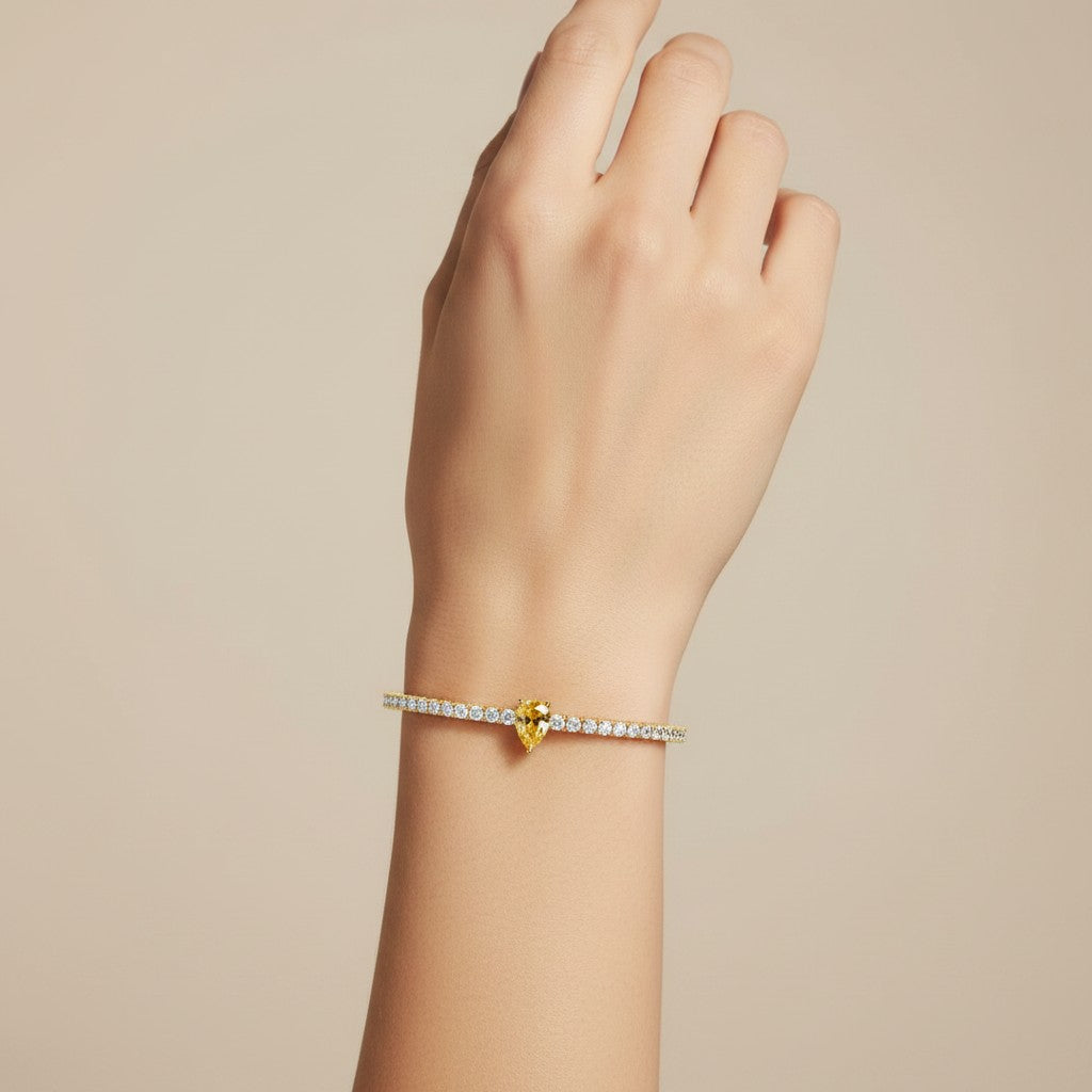 My Store 4 tennis bracelet featuring a central pear-cut fancy yellow diamond surrounded by round white diamonds in gold