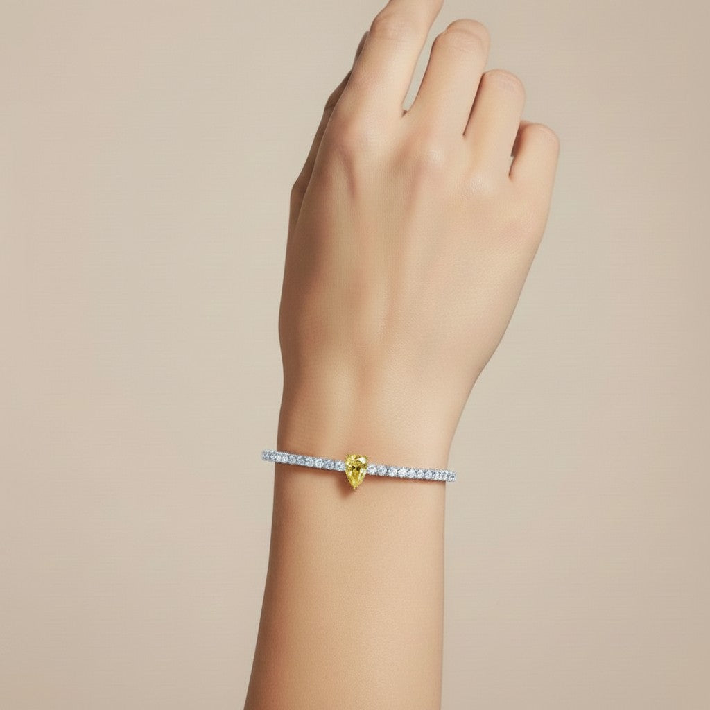 My Store 4 tennis bracelet featuring a central fancy yellow pear-cut diamond on a line of round white diamonds.