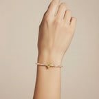 My Store 4 tennis bracelet featuring a central fancy yellow pear-cut diamond on a line of round white diamonds.