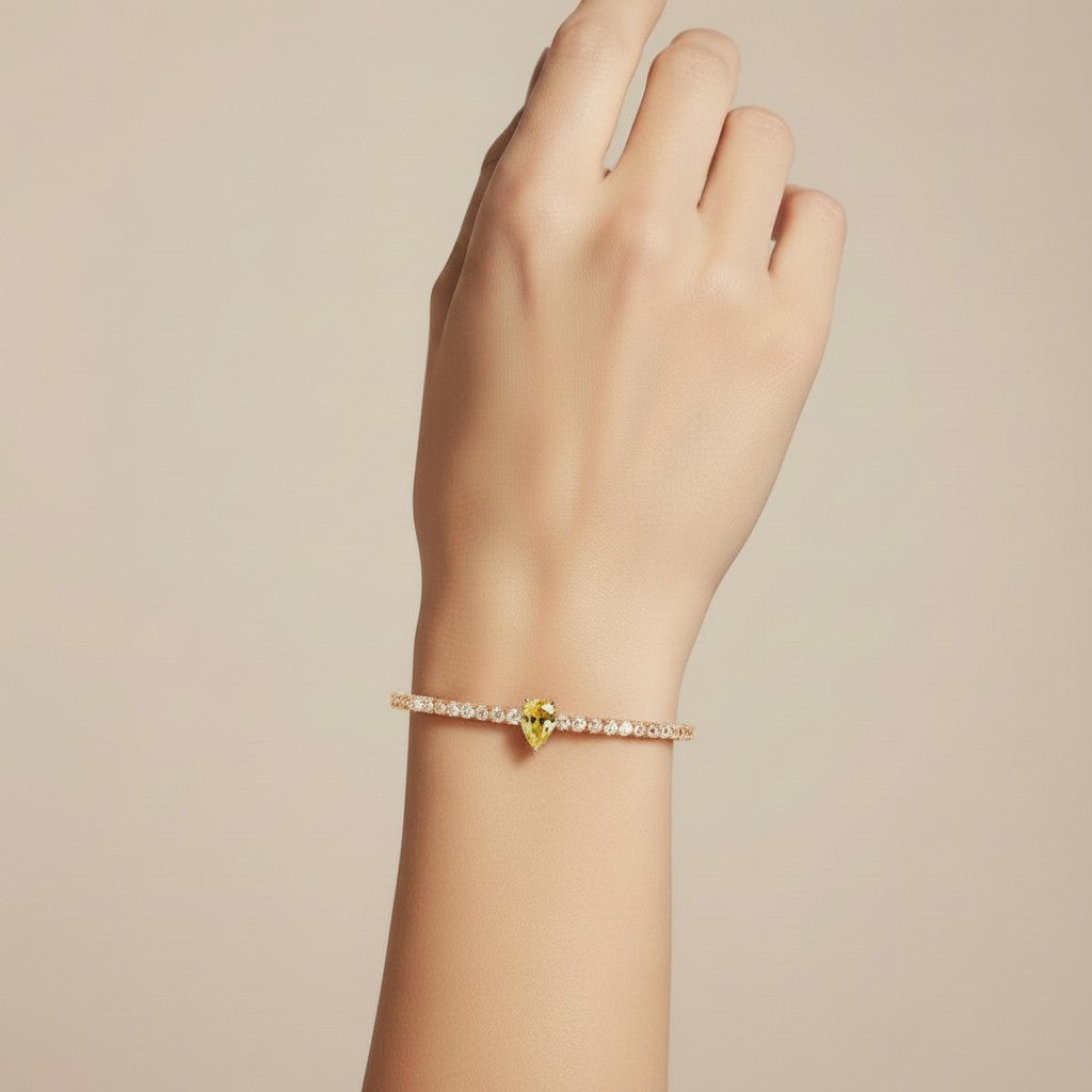 My Store 4 tennis bracelet featuring a central fancy yellow pear-cut diamond on a line of round white diamonds.
