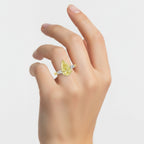 My Store 4 18K solid gold trilogy ring featuring a pear-cut yellow diamond and baguette side diamonds on a hand.