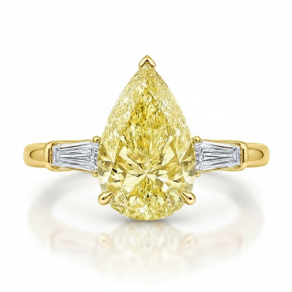 My Store 4 18K solid gold trilogy ring featuring a pear-cut fancy yellow diamond flanked by baguette-cut diamonds.