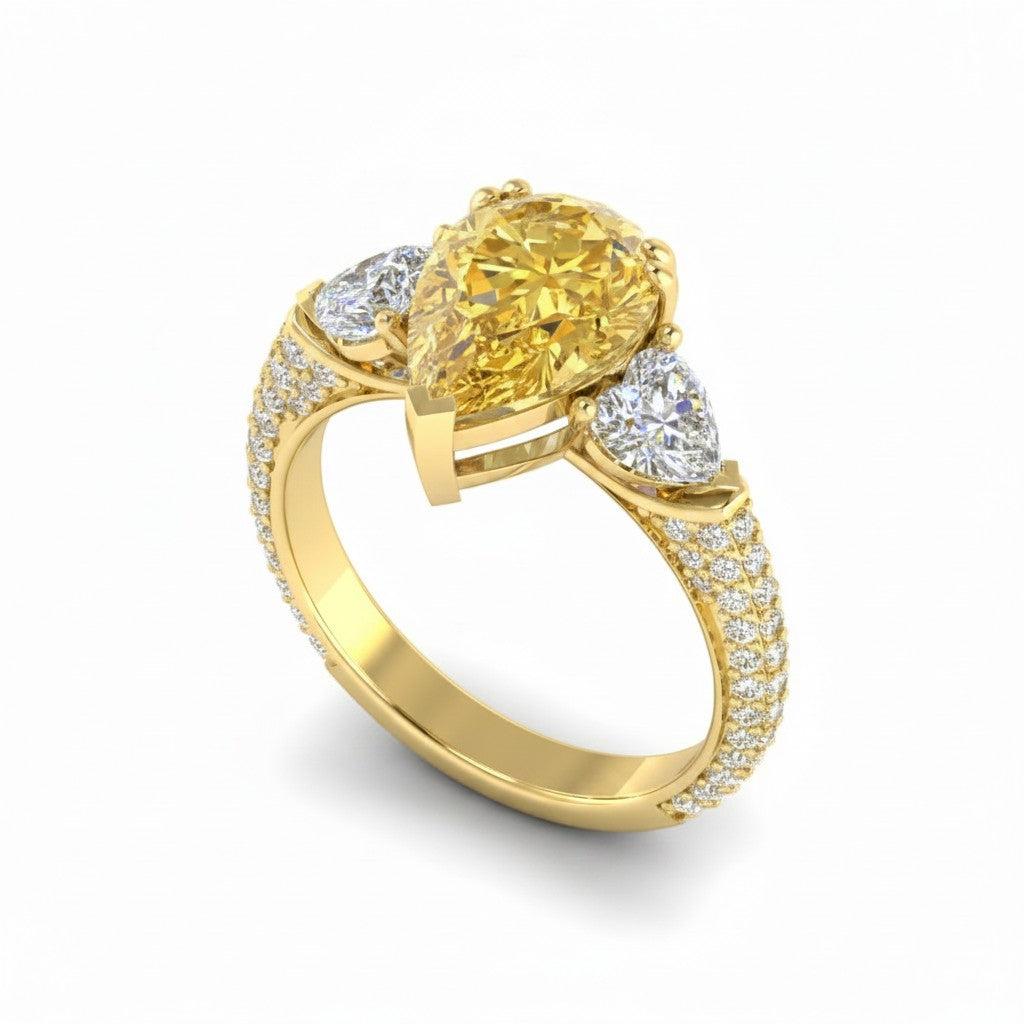 My Store 4 18K solid gold trilogy ring featuring a fancy yellow pear-cut lab diamond with pavé side stones.