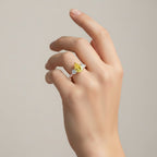 My Store 4 18K solid gold trilogy ring featuring a fancy yellow pear-cut lab diamond on a woman's hand.