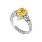 My Store 4 18K solid gold trilogy ring featuring a fancy yellow pear-cut lab diamond with side stones.