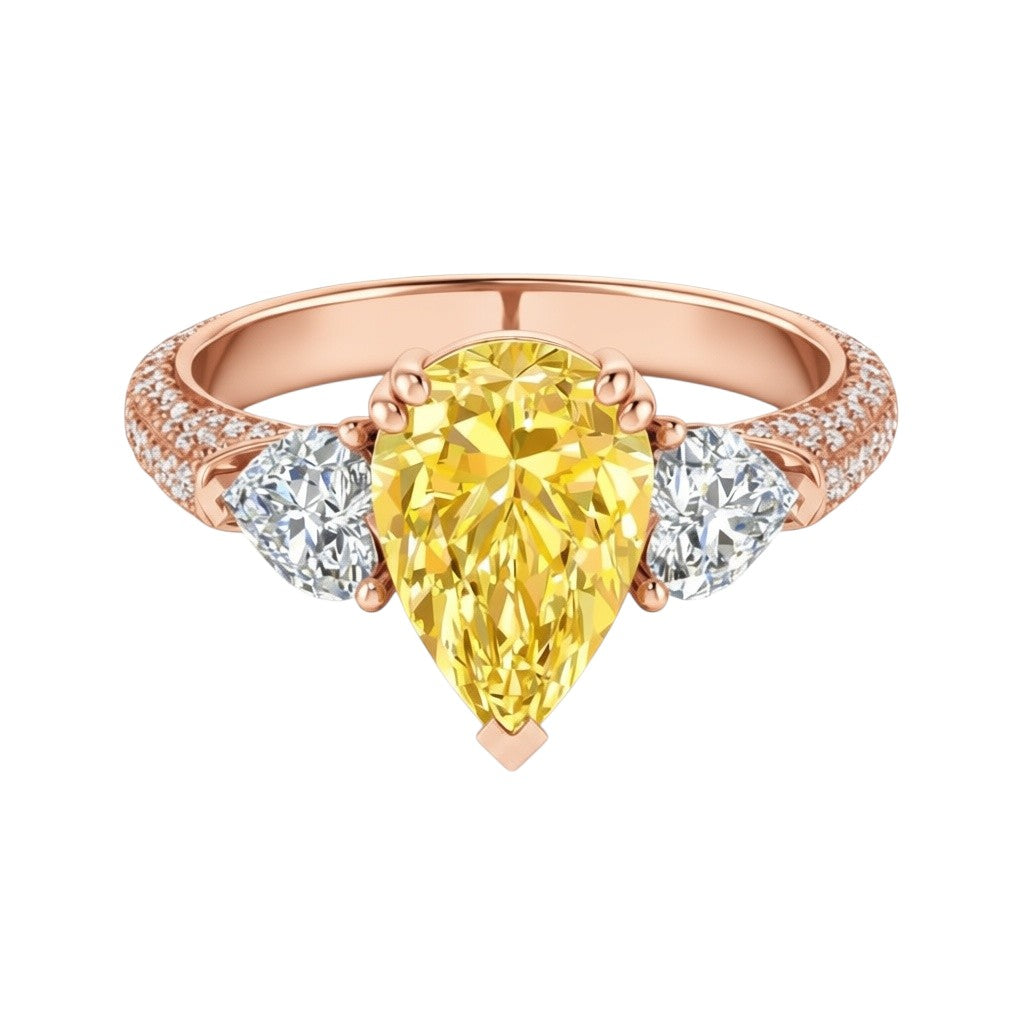 My Store 4 18K solid gold trilogy ring featuring a fancy yellow pear-cut lab diamond flanked by two side diamonds.
