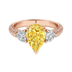 My Store 4 18K solid gold trilogy ring featuring a fancy yellow pear-cut lab diamond flanked by two side diamonds.