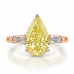 My Store 4 18K solid gold trilogy ring featuring a fancy yellow pear-cut diamond flanked by baguette side diamonds.