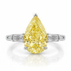 My Store 4 18K gold trilogy ring featuring a pear-cut fancy yellow diamond with baguette-cut side diamonds.