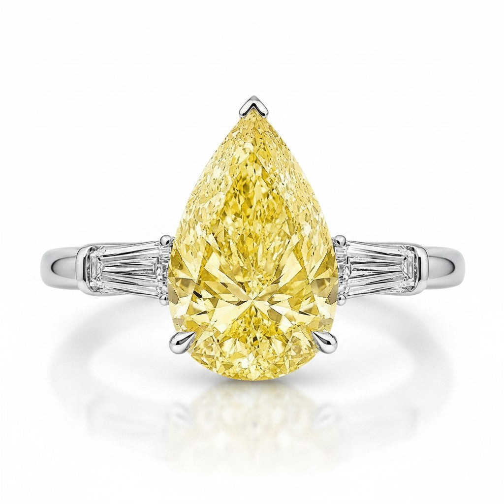 My Store 4 18K gold trilogy ring featuring a pear-cut fancy yellow diamond with baguette-cut side diamonds.