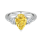 My Store 4 18K gold trilogy ring featuring a fancy yellow pear-cut lab diamond flanked by two side diamonds.