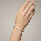 My Store 4 two-tone tennis bracelet featuring fancy yellow cushion-cut and white pear-cut diamonds on a woman's wrist.