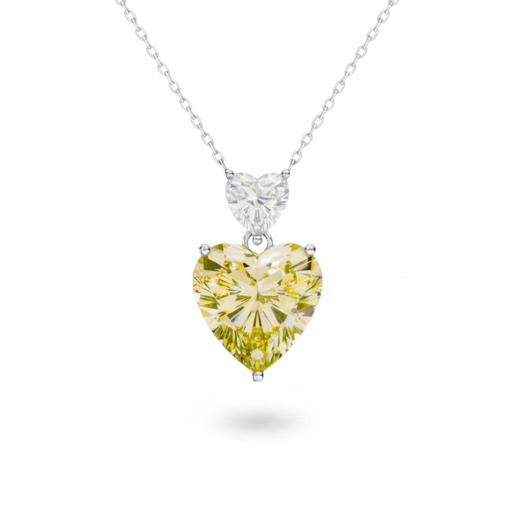 My Store 4 pendant necklace featuring a large fancy yellow heart-cut diamond drop suspended from a white heart diamond bail