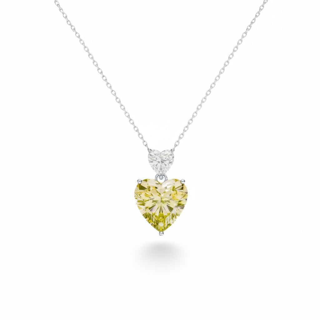 My Store 4 pendant necklace featuring a large fancy yellow heart-cut diamond drop with a white heart-cut diamond bail.