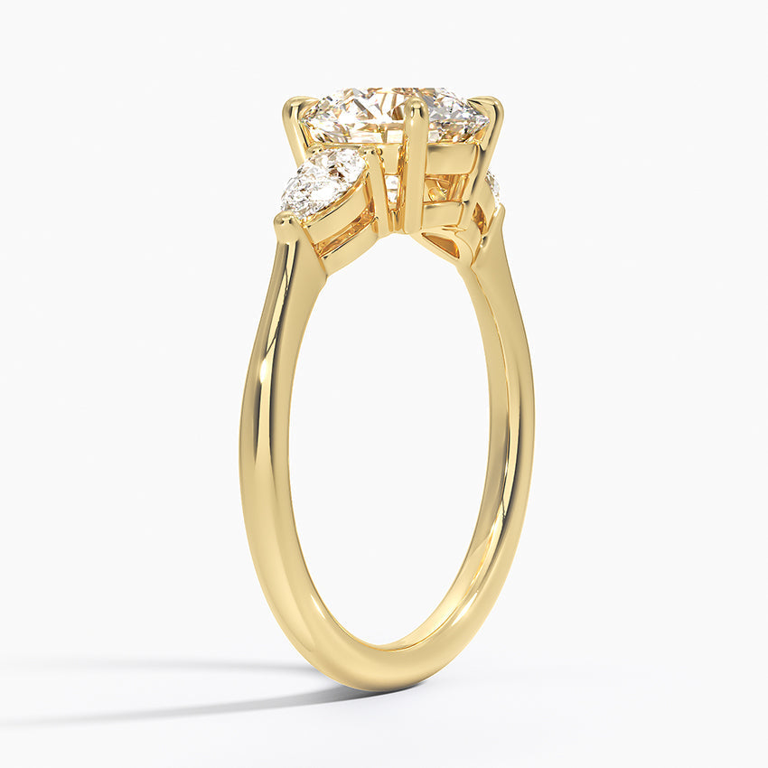 Round Cut Three-Stone Engagement Ring with Pear Side Accents in Solid Gold⁠