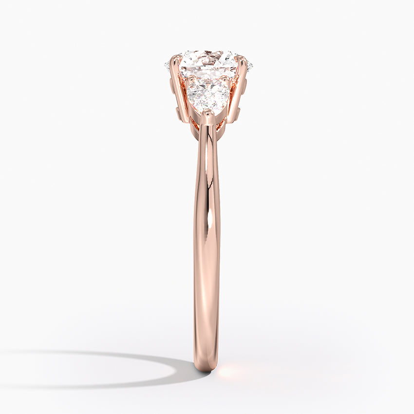 Round Cut Three-Stone Engagement Ring with Pear Side Accents in Solid Gold⁠