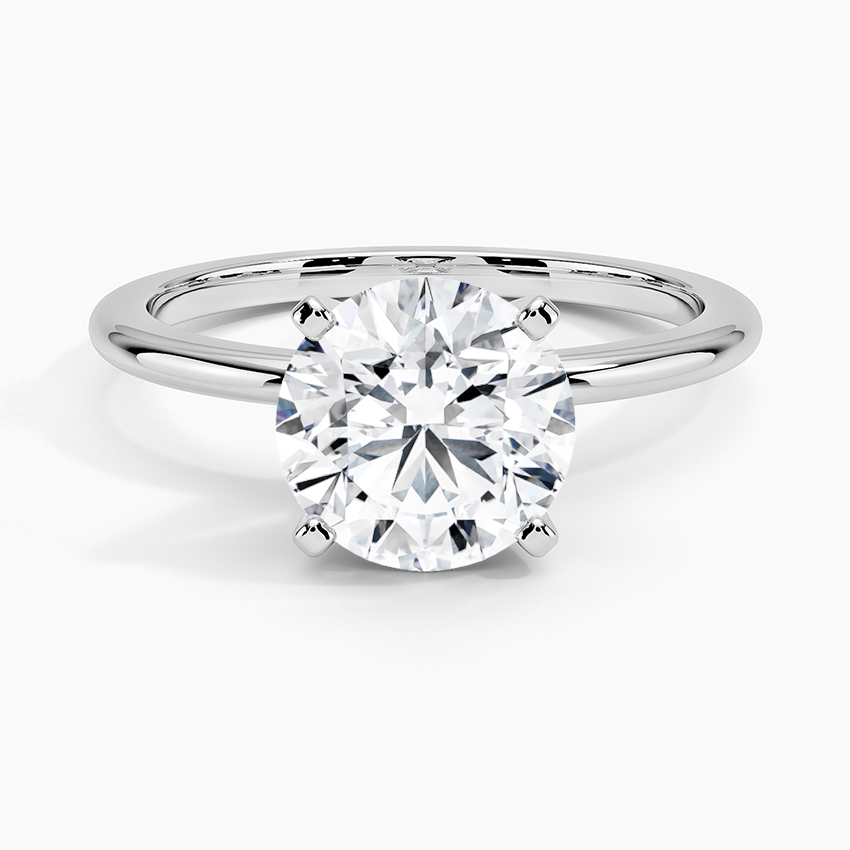 Round lab-grown diamond solitaire engagement ring with four-prong white gold setting