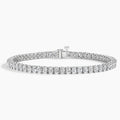 Oval cut diamond tennis bracelet in white gold with secure clasp on white background