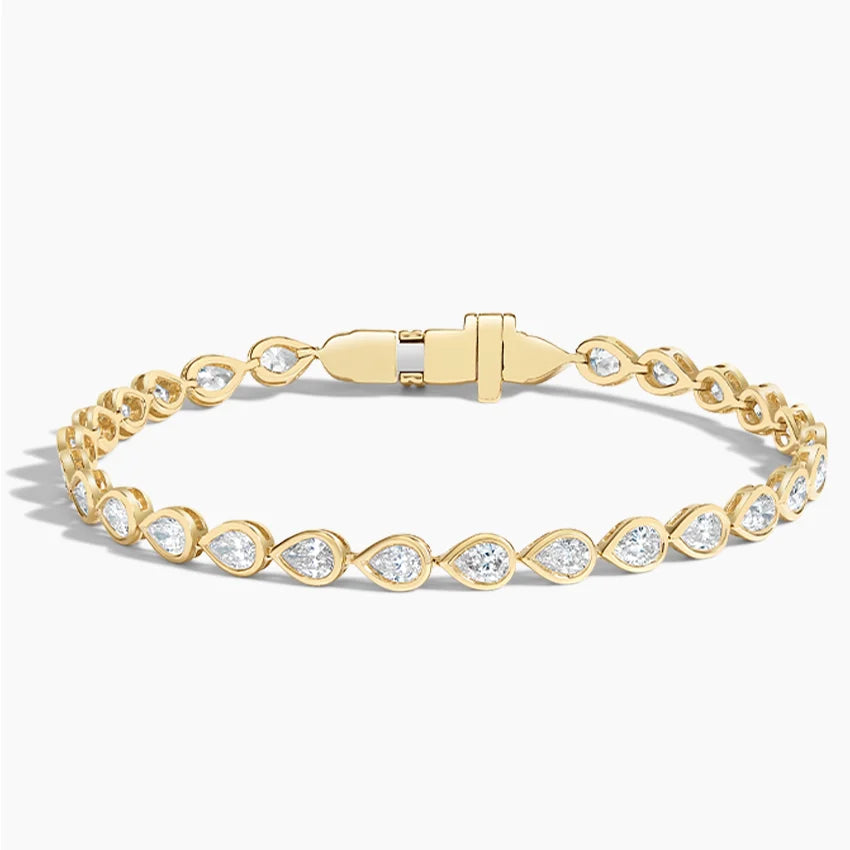 Gold tennis bracelet with pear-shaped lab-grown diamonds on a white background