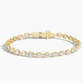 Gold tennis bracelet with pear-shaped lab-grown diamonds on a white background
