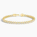 Yellow gold tennis bracelet with round lab-grown diamonds, bezel set, on white background